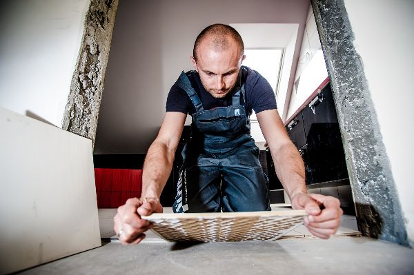 AdamMiller.Realtor - picture of man laying ceramic tile from pixabay.com